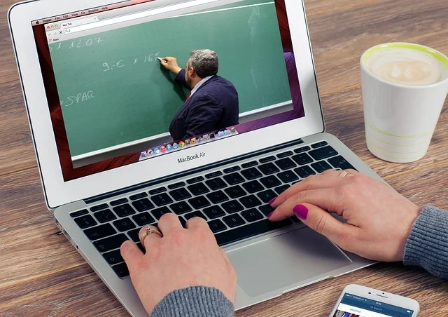 A person watching an online math lecture on a laptop