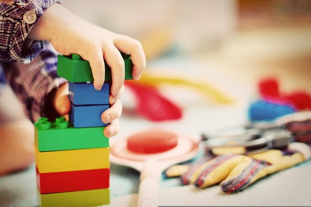 Fractions: A child stacking colorful toy building blocks