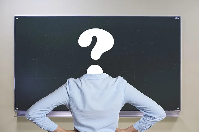 Derivative of sin x: A person with a question mark head standing before a blackboard
