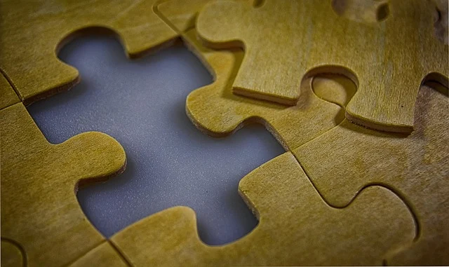 Wooden jigsaw puzzle pieces with one missing piece