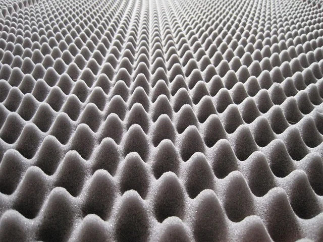 Acoustic foam with a wavy, repeating pattern, resembling trigonometric graphs.