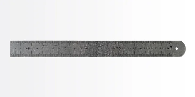 A metal ruler with numerical markings on a white background.