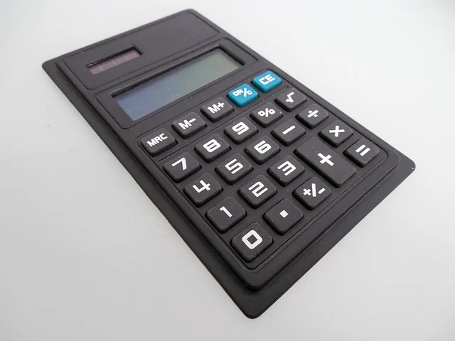 A black calculator on a white background.