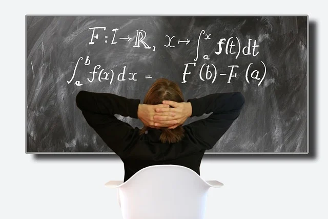 A person looking at calculus formulas written on a blackboard