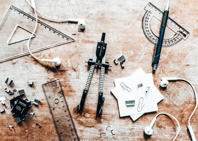 Trigonometric functions: Geometry tools like a protractor, ruler, and compass on a wooden desk.
