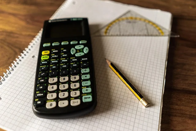 Calculator, protractor, pencil, and notebook for math studies
