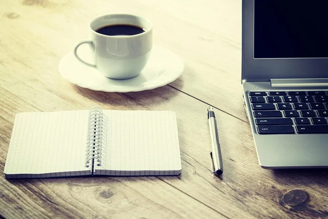 Derivative rules: A laptop, open notebook, pen, and coffee cup on a wooden desk