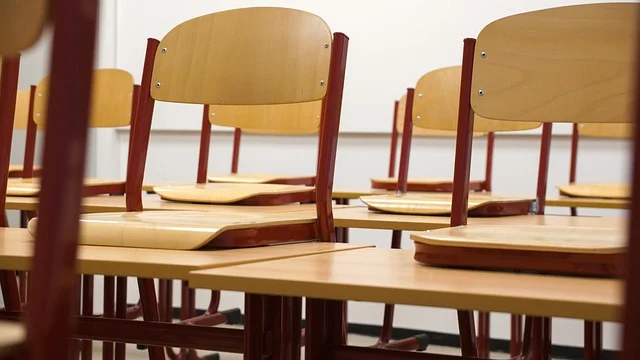 Empty classroom with wooden desks and chairs