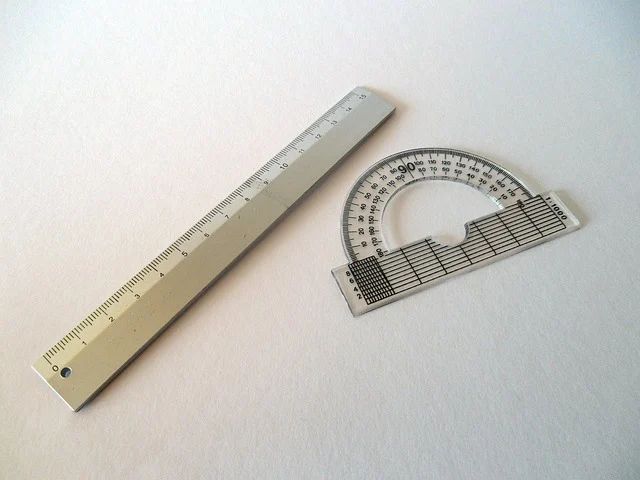 A ruler and a protractor on a white background.