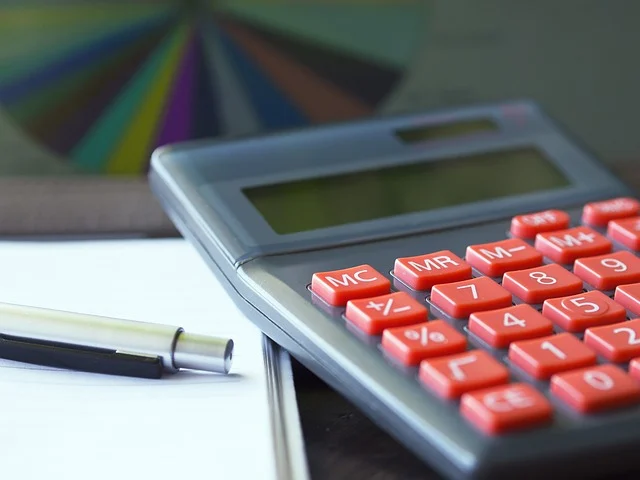 Z score: A calculator, pen, and paper with a pie chart in the background.