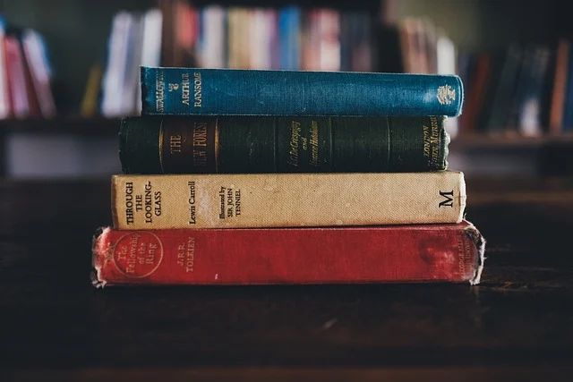Kinematic equations: A stack of old books with a bookshelf in the background.