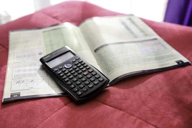 A calculator on an open textbook, likely for statistics or math.