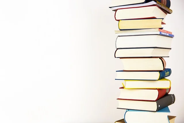A tall stack of colorful books against a white background